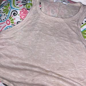 A tan colored tunic top with wide cut arms